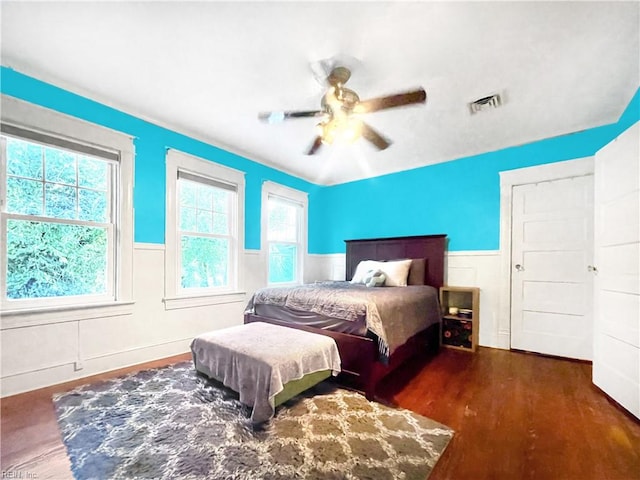 bedroom with ceiling fan and dark hardwood / wood-style floors