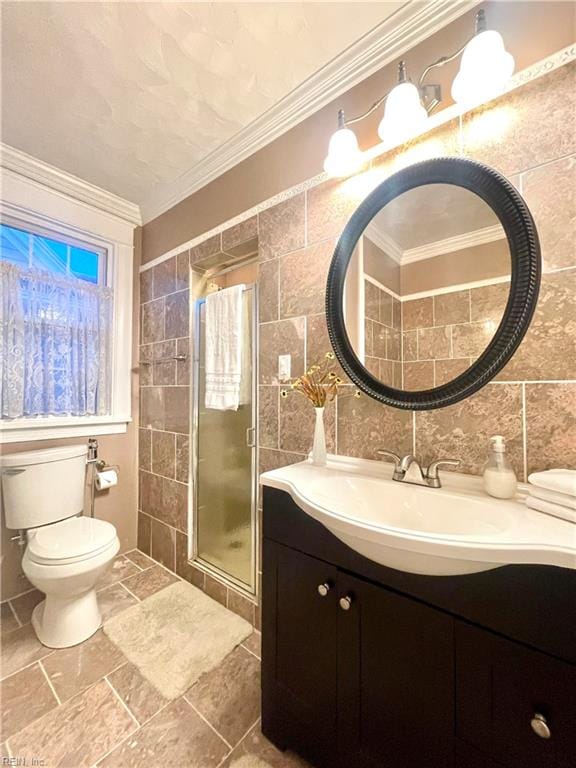 bathroom featuring backsplash, crown molding, an enclosed shower, vanity, and tile walls