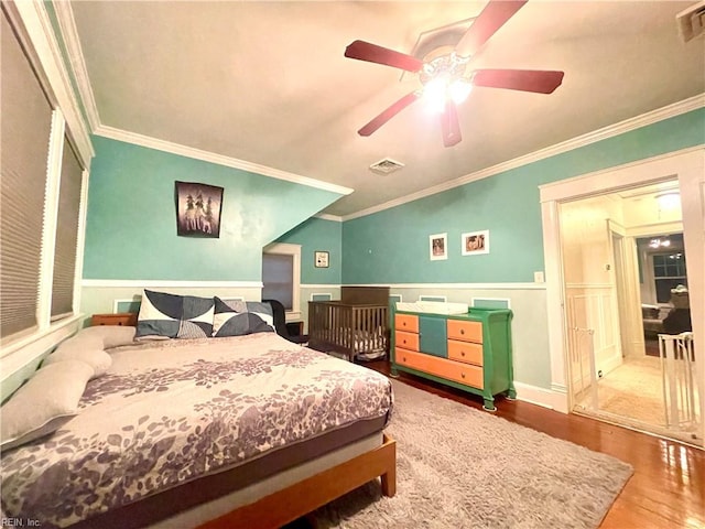 bedroom featuring ceiling fan, wood-type flooring, and crown molding