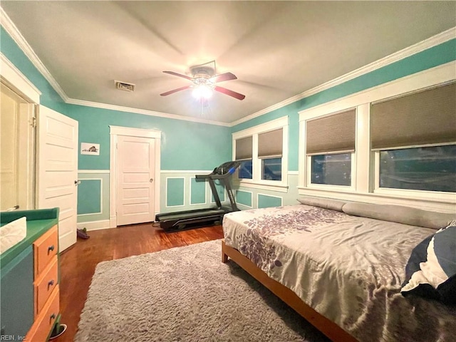 bedroom featuring ceiling fan, dark hardwood / wood-style flooring, and crown molding