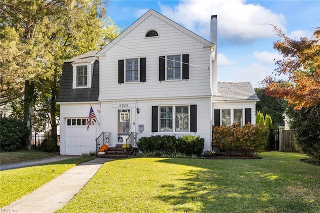 view of front of property with a garage and a front lawn