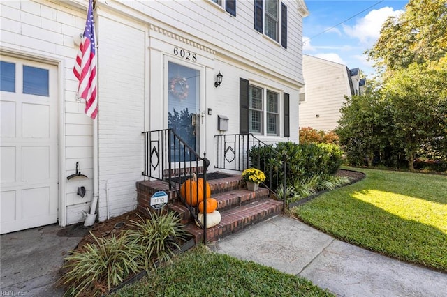 doorway to property with a lawn