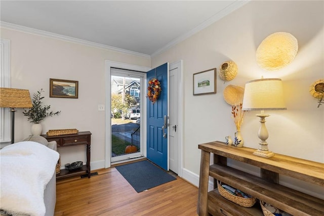 foyer entrance featuring wood-type flooring and ornamental molding