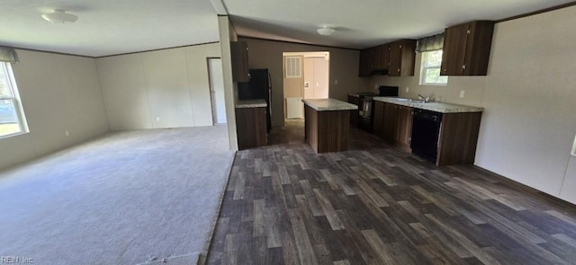 kitchen with dark brown cabinetry, black appliances, a center island, dark wood-type flooring, and vaulted ceiling