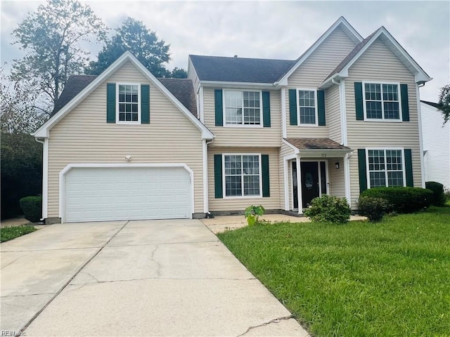 view of front of property with a garage and a front lawn