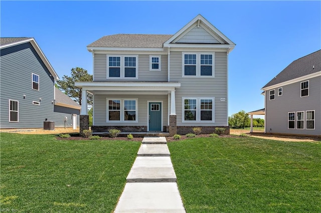 view of front of property with a front yard and central air condition unit