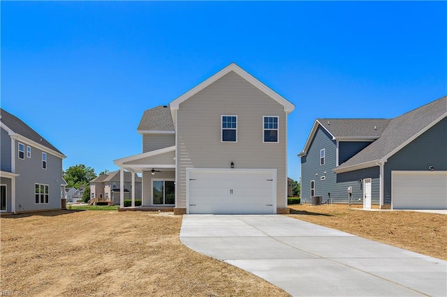 view of front of home featuring a front yard, central AC, and a garage