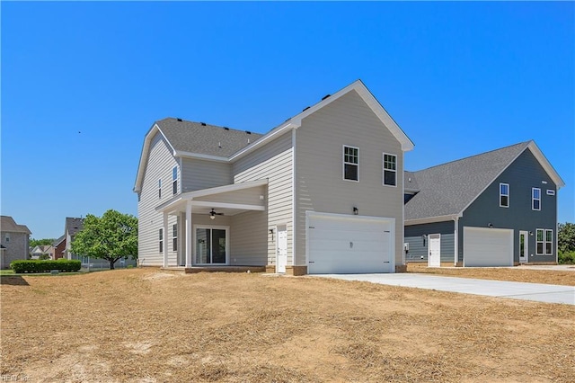 view of side of property featuring a garage and ceiling fan