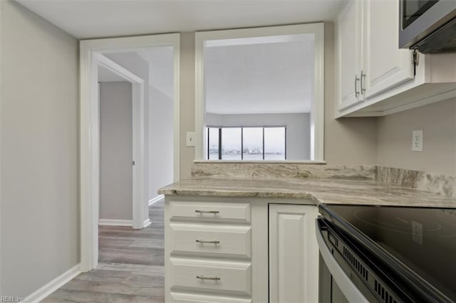 kitchen featuring white cabinets and light wood-type flooring