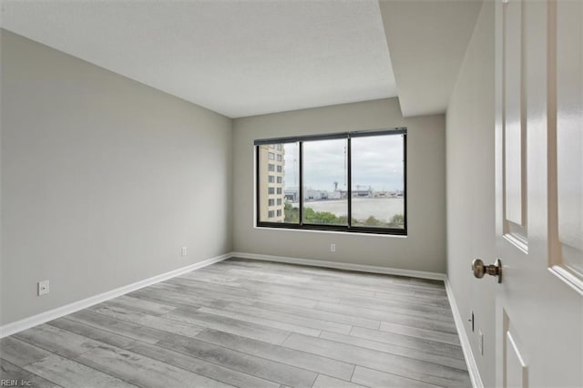 spare room featuring light hardwood / wood-style floors