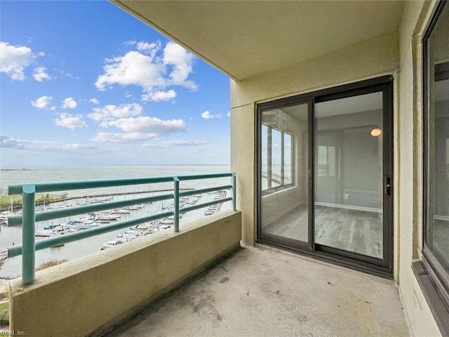 balcony featuring a water view and a beach view