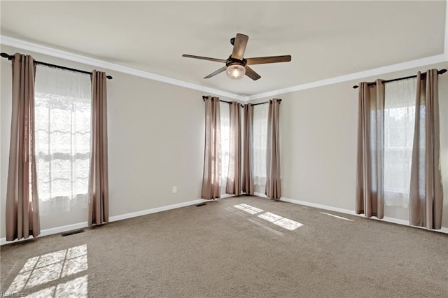 unfurnished room with a healthy amount of sunlight, light carpet, and crown molding