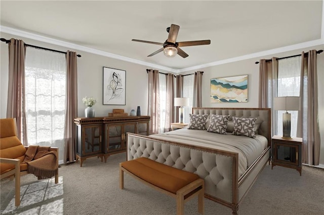 carpeted bedroom featuring ceiling fan, multiple windows, and crown molding