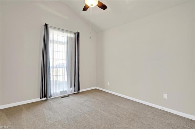 carpeted empty room with lofted ceiling and ceiling fan