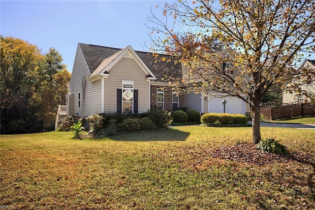 view of front of property with a garage and a front lawn