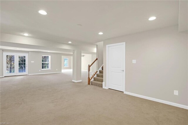 basement featuring light carpet