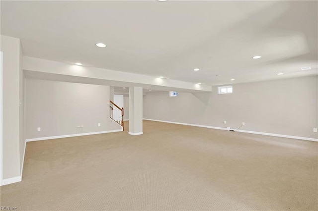 basement featuring light carpet