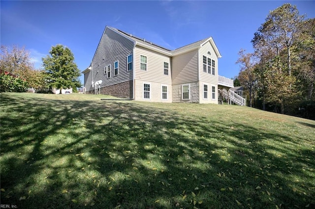 rear view of property featuring a yard