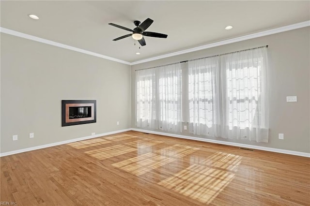 spare room featuring ornamental molding, hardwood / wood-style floors, and ceiling fan