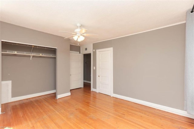 unfurnished bedroom featuring a closet, light hardwood / wood-style floors, and ceiling fan