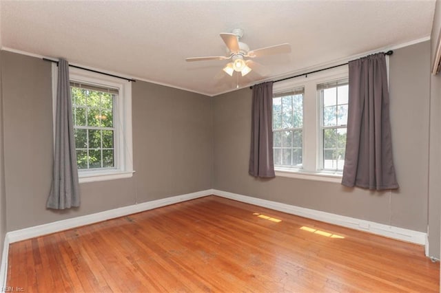 unfurnished room featuring ornamental molding, light hardwood / wood-style floors, and ceiling fan