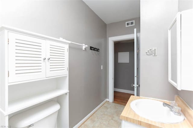 bathroom featuring vanity and toilet