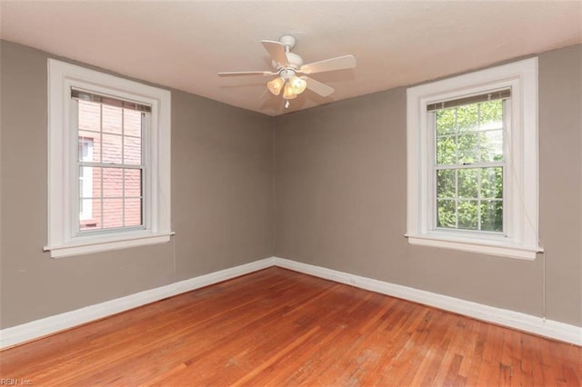 empty room featuring hardwood / wood-style flooring and ceiling fan