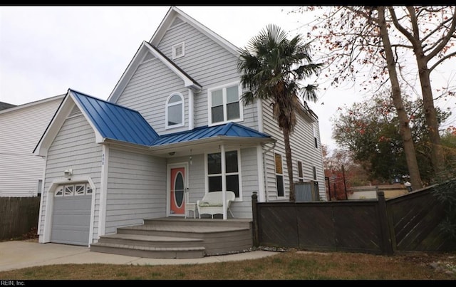 view of front property with a porch and a garage