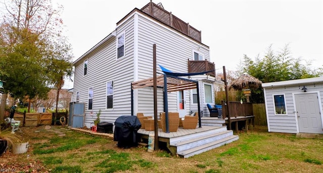 rear view of property with a lawn and a deck