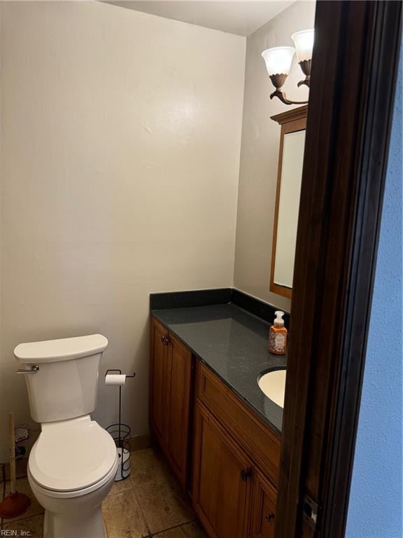 bathroom featuring vanity, toilet, and tile patterned flooring