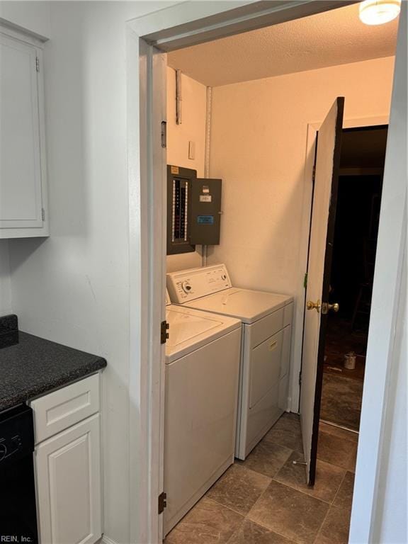 laundry room with electric panel and washing machine and clothes dryer