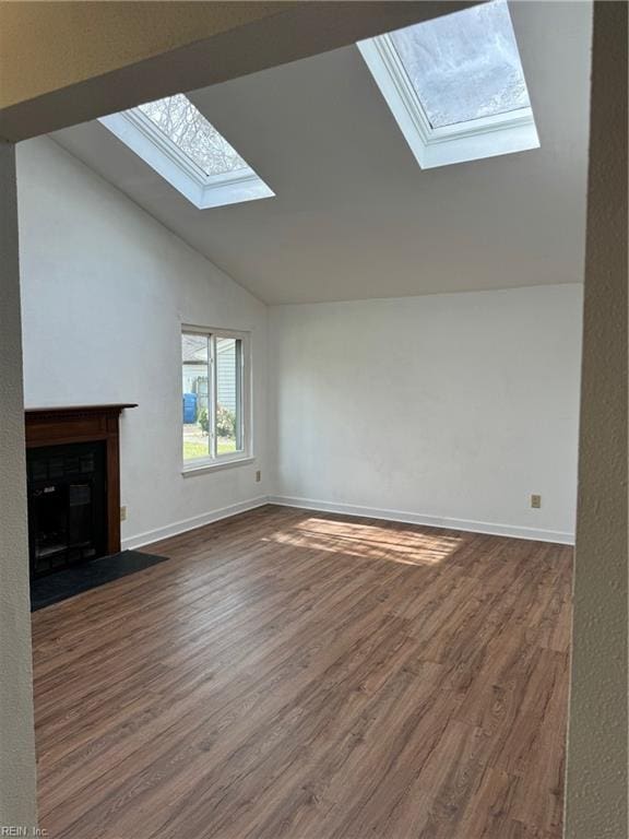 unfurnished living room with dark hardwood / wood-style flooring and vaulted ceiling