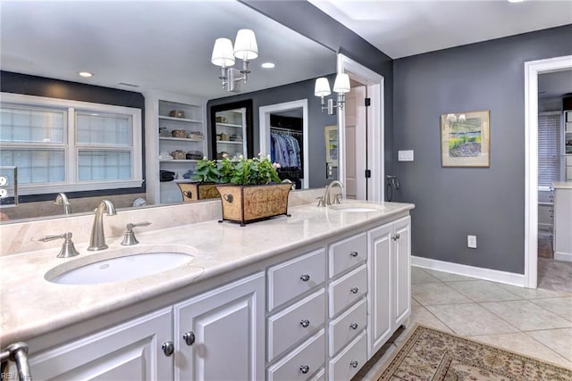 bathroom featuring built in features, vanity, and tile patterned floors