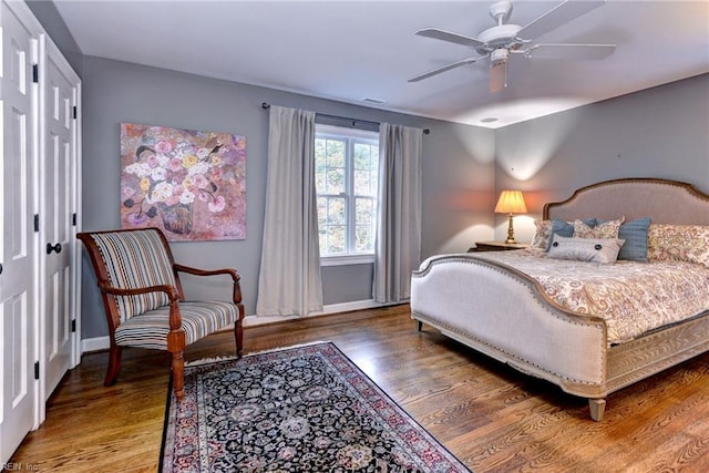 bedroom with ceiling fan and wood-type flooring