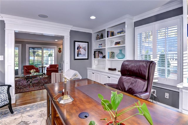 office featuring crown molding, a healthy amount of sunlight, and light hardwood / wood-style flooring