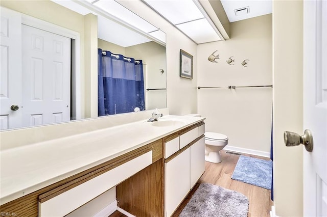 bathroom with vanity, a shower with curtain, wood-type flooring, and toilet