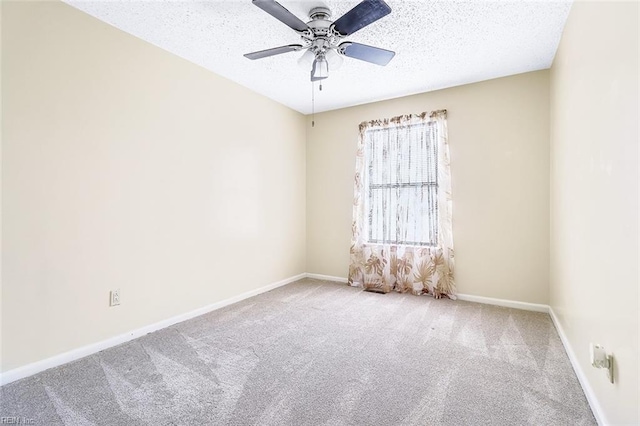 empty room featuring ceiling fan, a textured ceiling, and carpet flooring