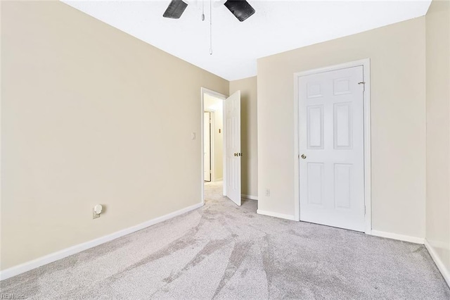 unfurnished bedroom with ceiling fan and light carpet