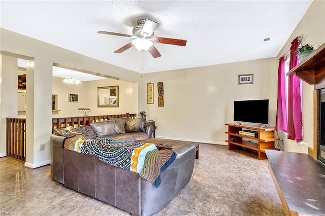 living room with a textured ceiling and ceiling fan with notable chandelier