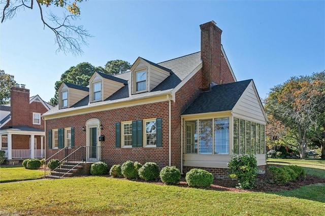 cape cod-style house featuring a front lawn