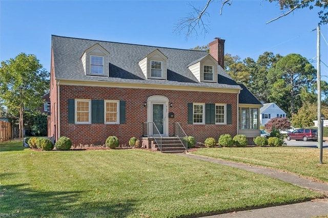 cape cod home featuring a front lawn