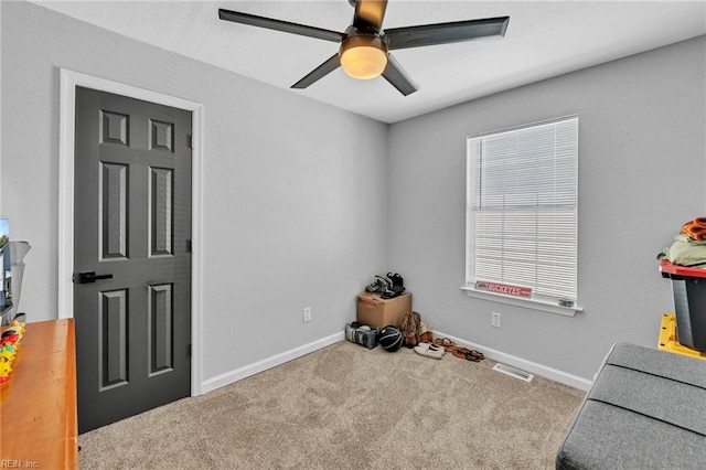 misc room with ceiling fan and carpet floors