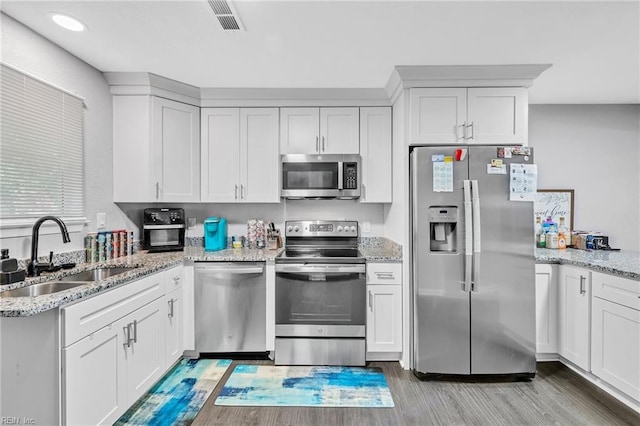 kitchen with white cabinetry, appliances with stainless steel finishes, and sink