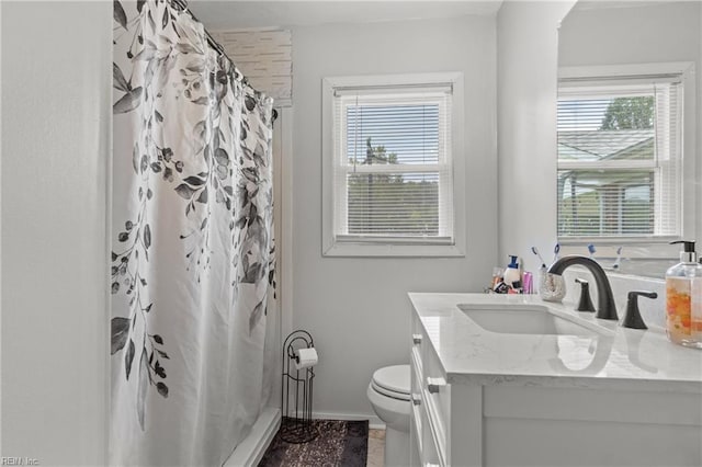 bathroom with walk in shower, vanity, and toilet