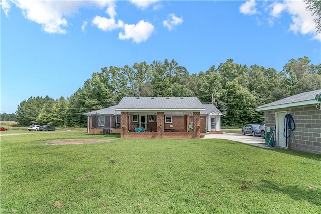 rear view of house featuring a yard