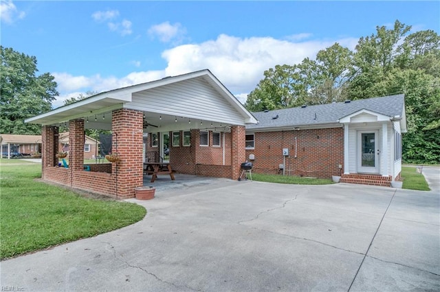 view of front of home with a patio, a front yard, and ceiling fan