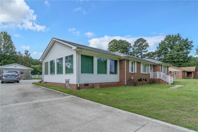 view of front of property featuring a front lawn, a garage, and an outdoor structure