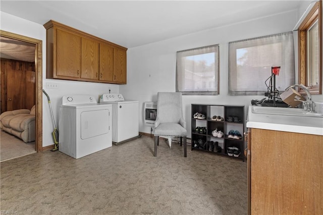 laundry area featuring cabinets, sink, heating unit, independent washer and dryer, and light colored carpet