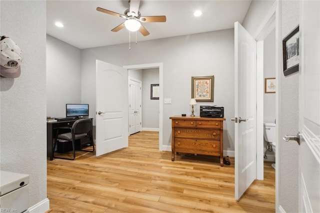 office with ceiling fan and light hardwood / wood-style flooring