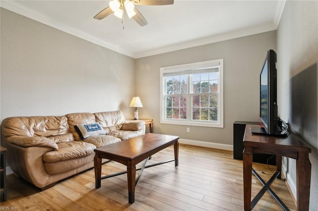 living room with ornamental molding, ceiling fan, and light hardwood / wood-style floors